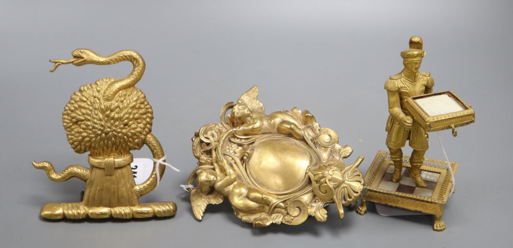 An ormolu figural stand and two decorative gilt metal furniture mounts